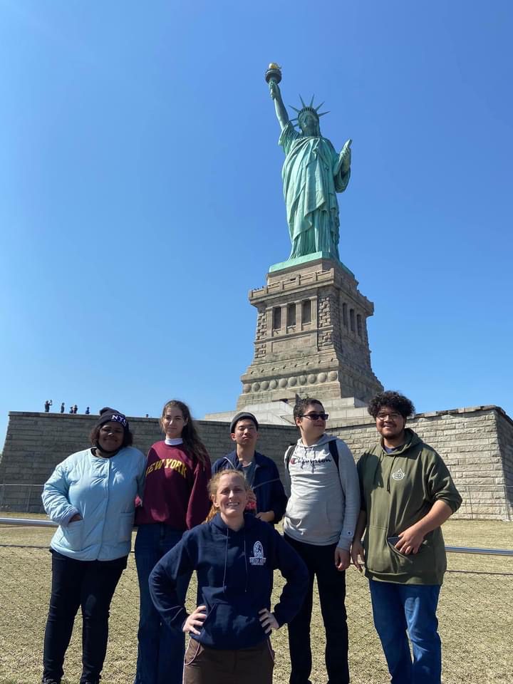 students in front of the Statue of Liberty
