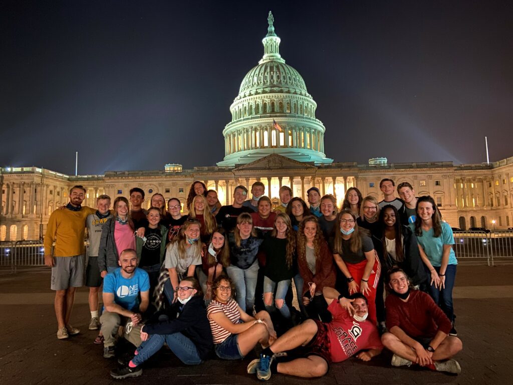 group of young people posing in front of the capitol building